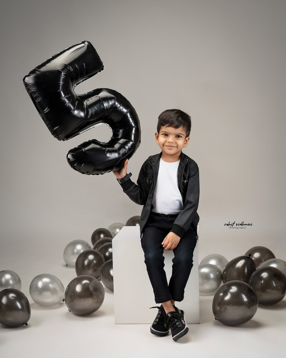 Kids birthday photoshoot, boy in denim with gift boxes