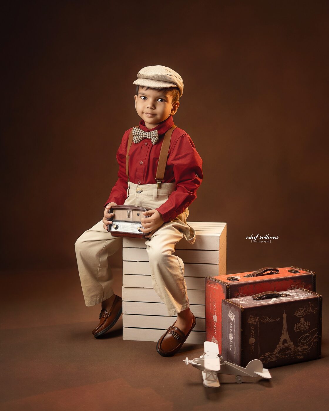 Kids vintage traveler themed photoshoot with suitcases